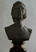 Bust of a man with beard on a pedestal.