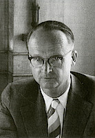 A man wearing glasses and a tie.