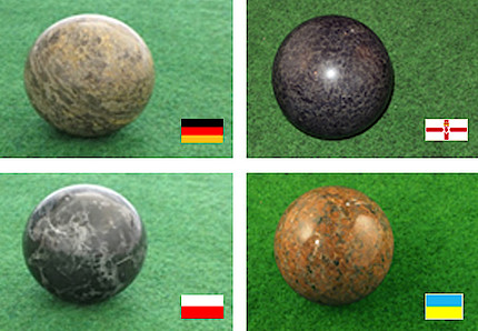 Vier Kugeln aus Gestein mit Flaggen der jeweiligen Herkunftsländer daneben