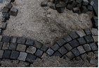 Viennese cobblestones - a part laid in sheets. The vacancy is gravel and paving stones heap.