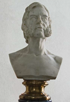 Bust of a man with beard on a pedestal.
