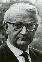 A man wearing glasses and a tie.