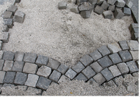 Viennese cobblestones - a part laid in sheets. The vacancy is gravel and paving stones heap.